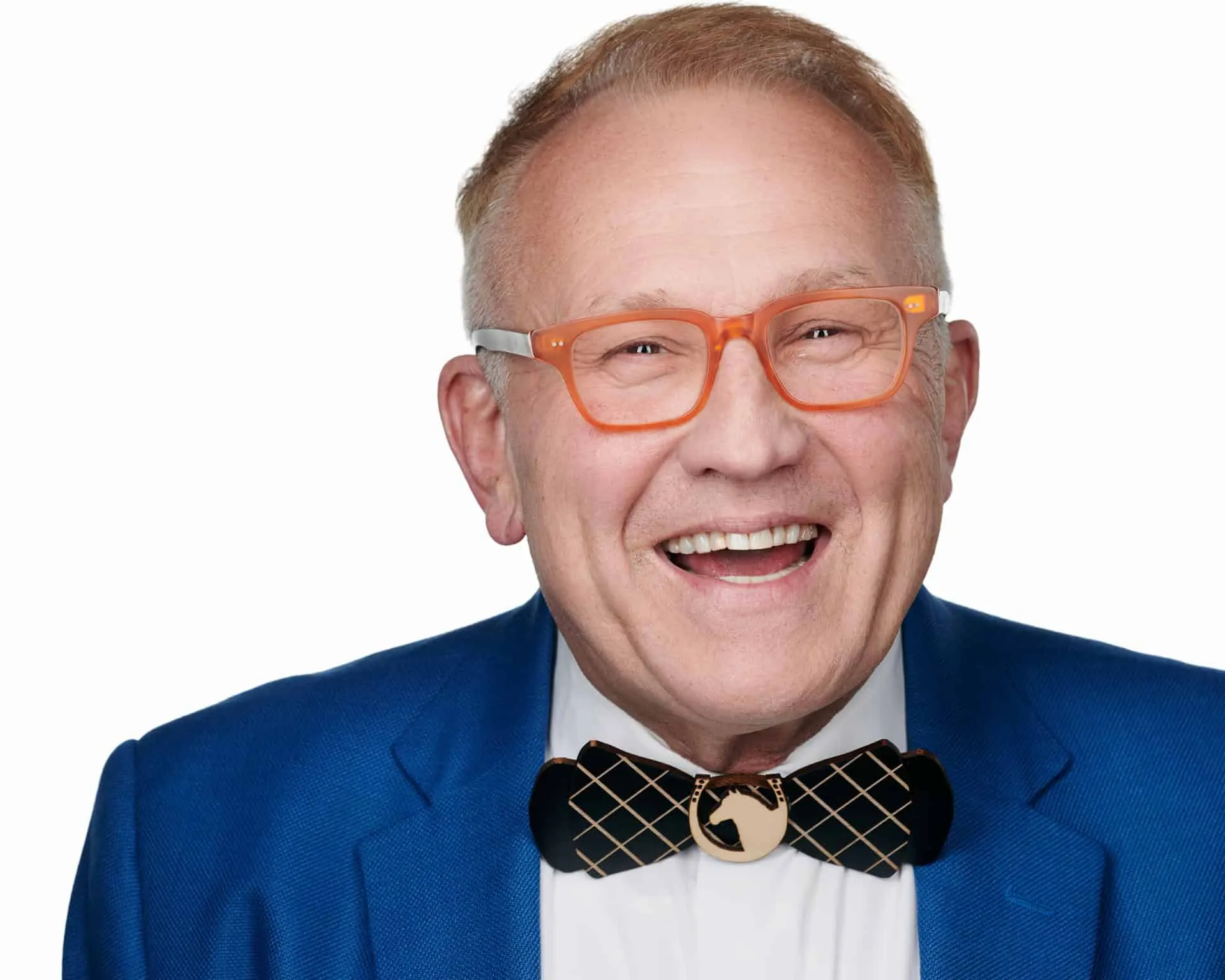 Professional business headshot by Ben Marcum Photography of male executive with short brown hair, bright orange rectangular frame glasses, wide genuine smile showing teeth, wearing royal blue textured blazer over white dress shirt with black and tan geometric patterned bow tie on seamless white background, Louisville Kentucky corporate photography