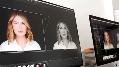 Professional photography workstation displaying headshot editing software on dual monitors showing color portrait and black and white conversion of woman with wavy blonde hair in white collared shirt at Richard Waine Photography Lancaster Pennsylvania studio