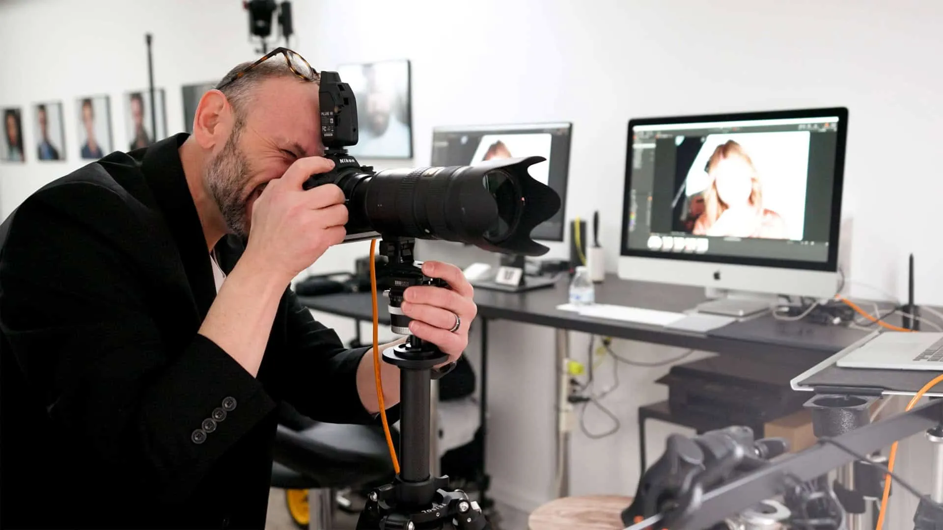 Professional headshot photographer Richard Waine photographing an actor in Lancaster PA studio with dual monitor setup displaying acting headshots