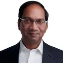 Professional executive headshot of man with receding hairline and rectangular glasses wearing dark suit jacket over white collared dress shirt against white studio background by Richard Waine Photography in Lancaster Pennsylvania photography studio